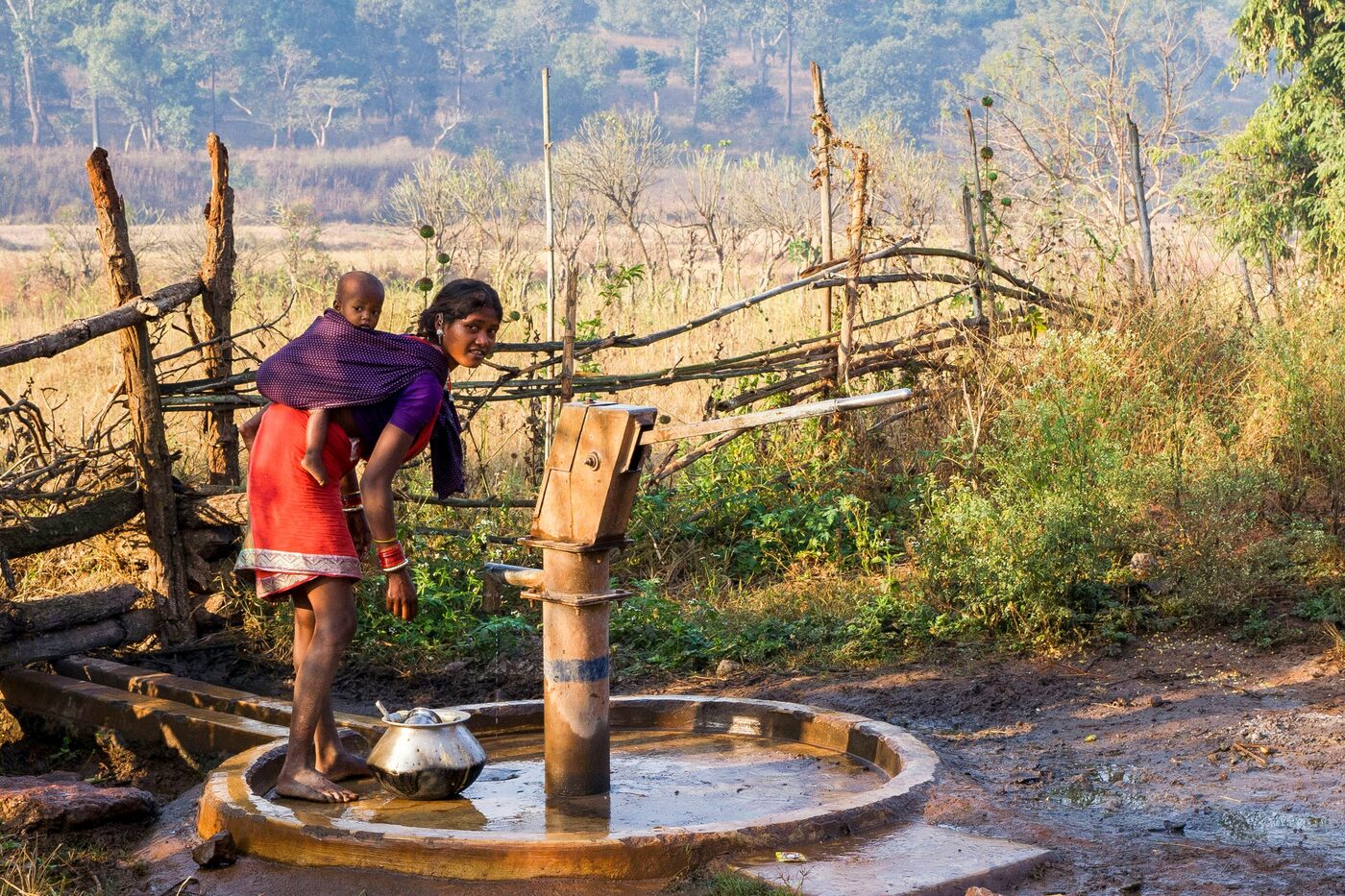 A woman drawing water from a community hand pump
